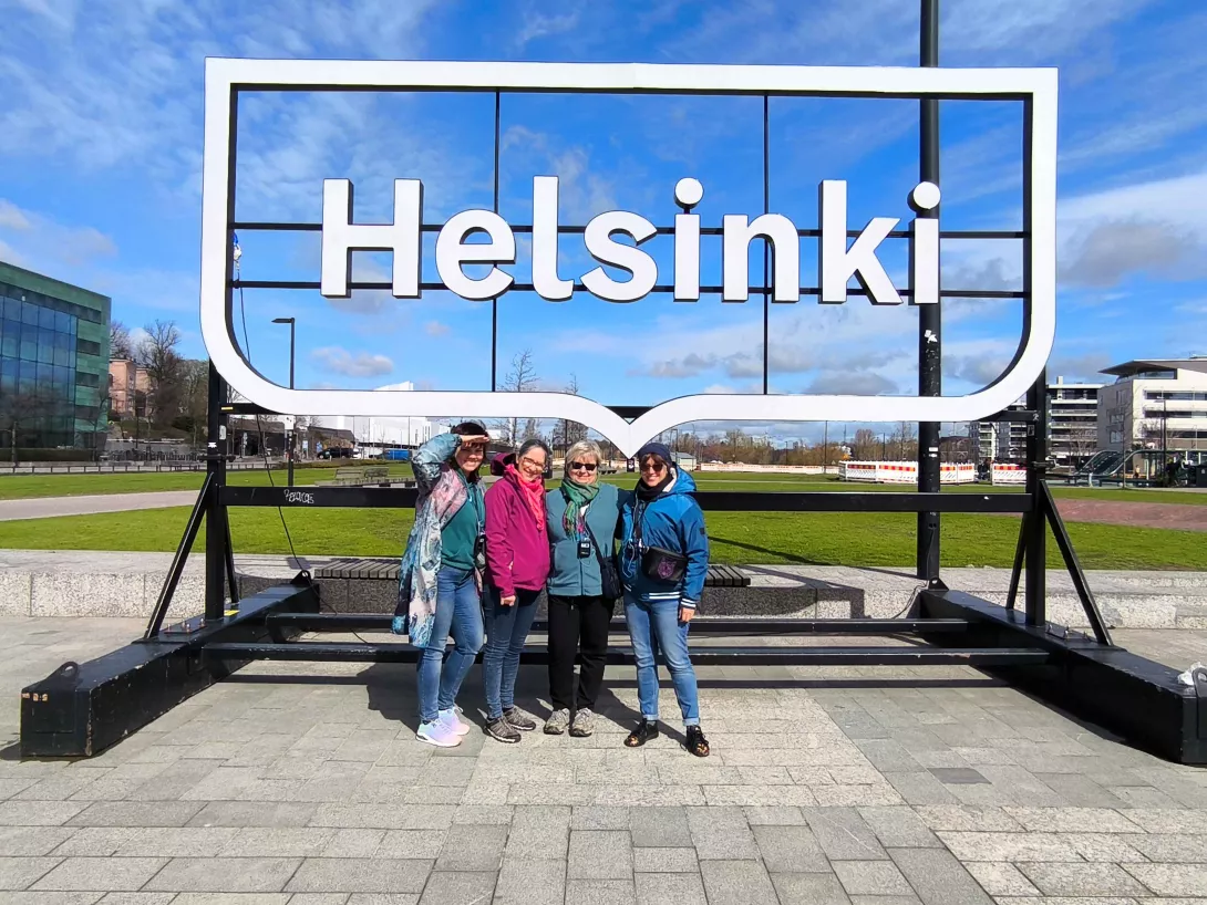 Nauczycielki, uczestniczące w wycieczce na tle napisu Helsinki.