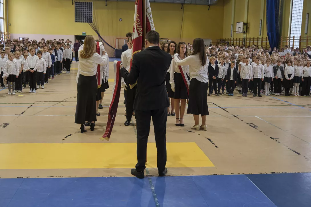 Ustępujący poczet sztandarowy przekazuje szarfy sztandarowe.